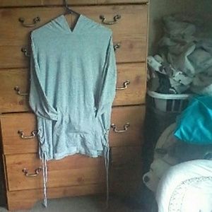 Grey long sleeve shirt with a pocket and hood